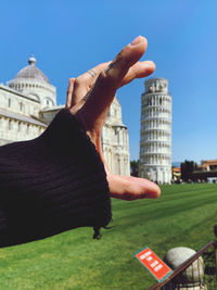 Rear view of woman sitting on field