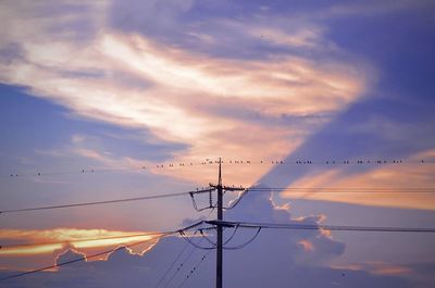 Low angle view of silhouette electricity pylon against sky during sunset