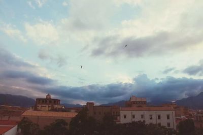 Buildings against cloudy sky