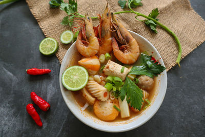 Tom yam soup originating from thailand. tom yum is made with shrimp, chili, lime, chicken, fish, or 