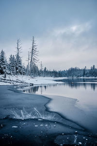 Scenic view of frozen lake against sky during winter