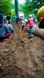 Group of people working on road