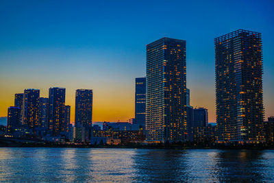 Modern buildings in city against clear sky