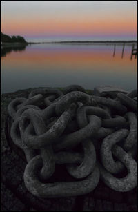Close-up of chain link fence in water
