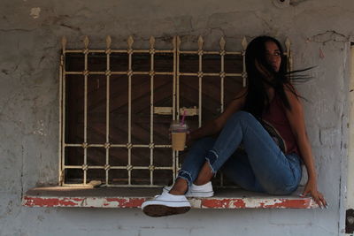 Woman sitting on wall