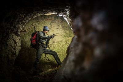 People on rock in cave