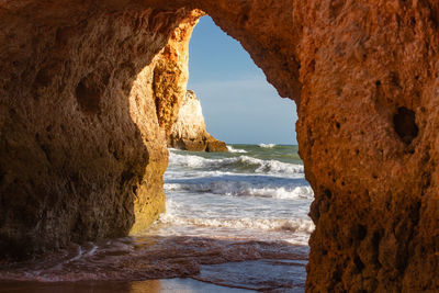 Scenic view of sea seen through rock formation