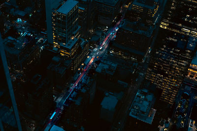 High angle view of illuminated buildings in city at night