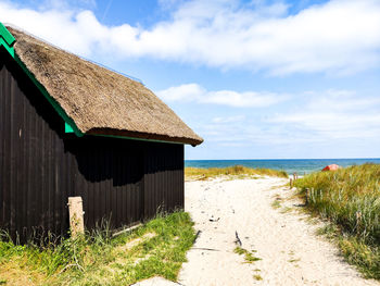 House by sea against sky