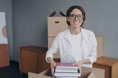 Portrait of young woman sitting on table