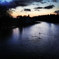 Scenic view of lake against cloudy sky
