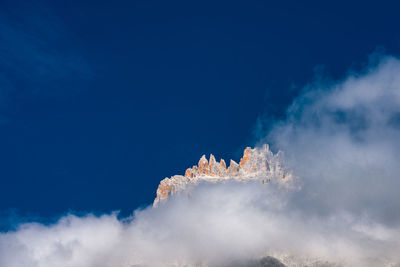 Low angle view of snowcapped mountain against sky