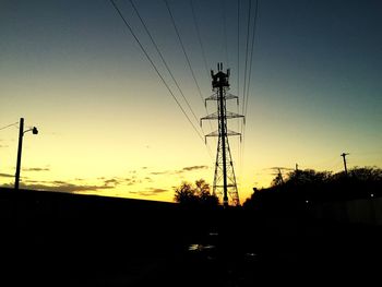 Low angle view of electricity pylon against sky