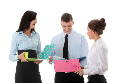 Friends standing against white background