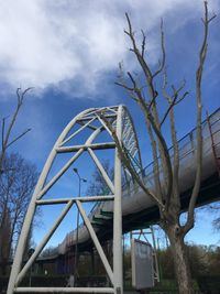 Low angle view of bare tree against cloudy sky