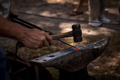 Cropped blacksmith working in workshop