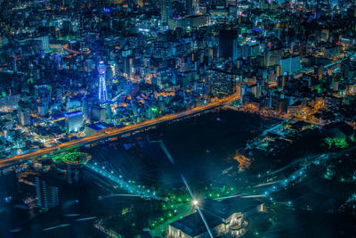 High angle view of illuminated buildings in city at night