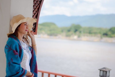 Portrait of young woman wearing hat