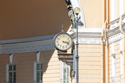 Street round vintage rare clock on the wall of the building