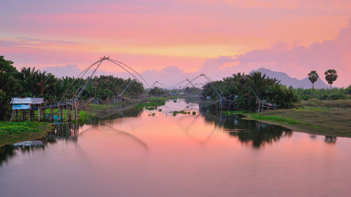 Scenic view of lake against sky at sunset