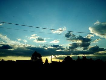 Low angle view of silhouette trees against sky at sunset