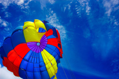 Low angle view of balloons against blue sky