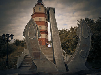 Close-up of clock tower against sky in city