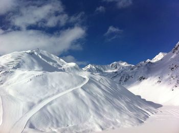 Scenic view of snowcapped mountains against sky