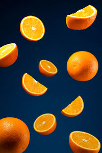 Close-up of orange slices against blue background