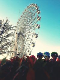 Low angle view of ferris wheel against clear sky