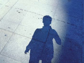 Shadow of man on street