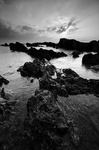 Rocks on beach against sky