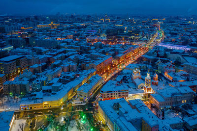 Aerial view of snow covered townscape at night