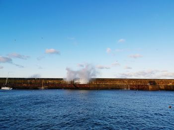 Smoke emitting from chimney against sky