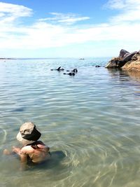 Man surfing in sea against sky