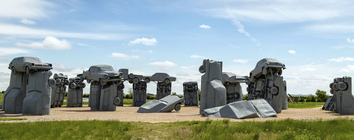 Panoramic shot of cemetery on field against sky