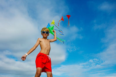 Full length of woman jumping against sky