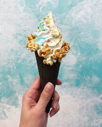 Close-up of hand holding ice cream cone