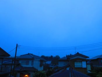 Houses against sky at dusk