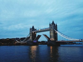 View of bridge over river against cloudy sky