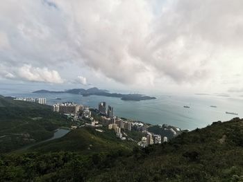 High angle view of buildings and sea against sky