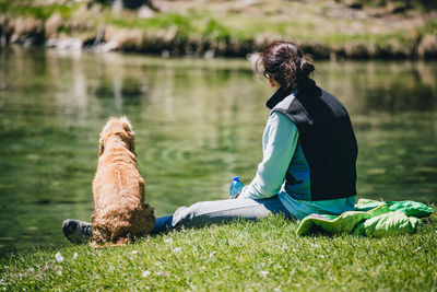 Man with dog sitting in a lake