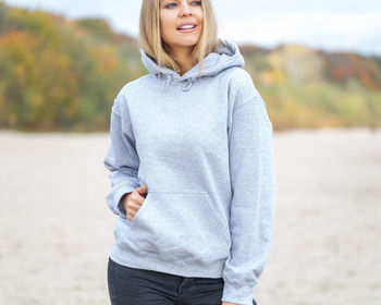 Portrait of a smiling young woman standing on land