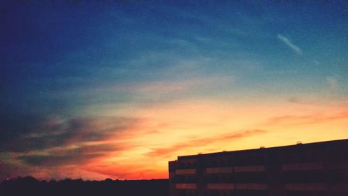 Low angle view of silhouette buildings against sky during sunset