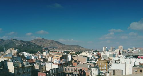 Cityscape and mountains against sky 