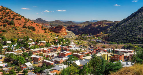 Scenic view of townscape and mountains against sky