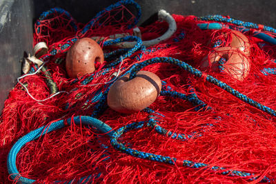 The object of red - blue fishing nets and floats lay at the marina of santa marinella,italy.