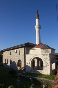 Low angle view of building against clear blue sky