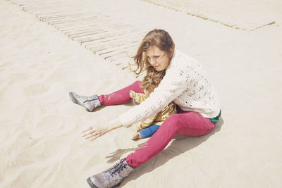 High angle view of woman sitting on beach