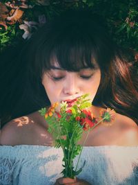 Portrait of young woman with flowers